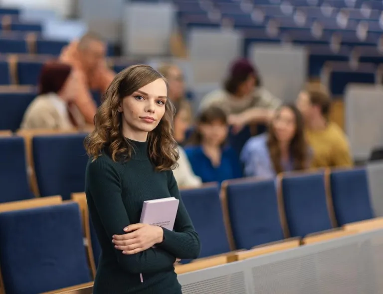 Przyznanie akredytacji | Uniwersytet WSB Merito Chorzów: studentka stojąca na auli wykładowej