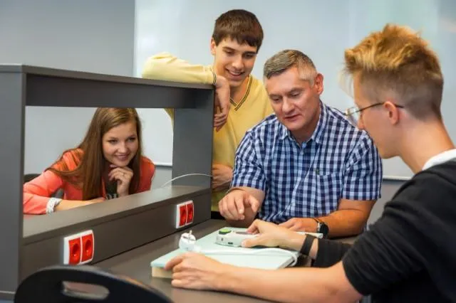 Bezpieczeństwo i higiena pracy | Studia I stopnia w Chorzowie | Uniwersytet WSB Merito Chorzów: studenci omawiający użycie urządzenia