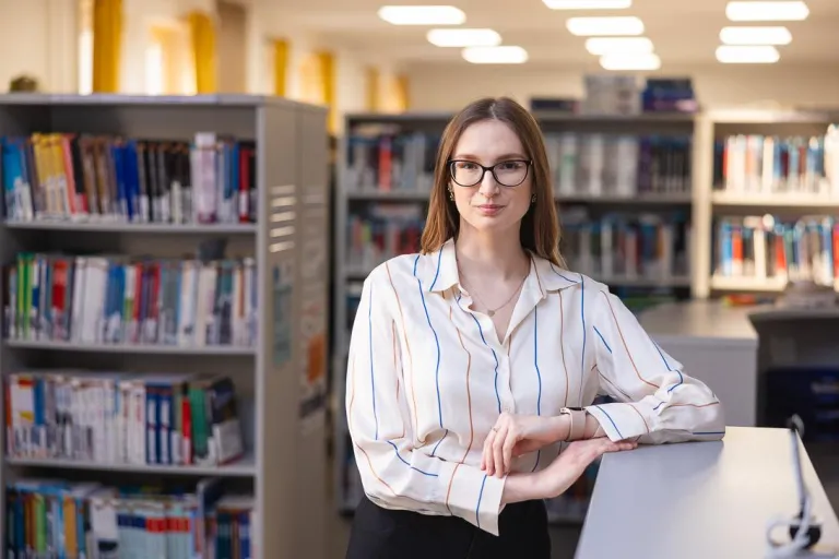 Resocjalizacja i socjoterapia | Uniwersytet WSB Merito Chorzów: Studentka stojąca w bibliotece