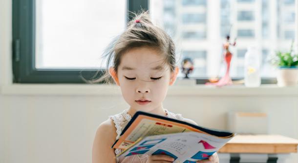 child girl reading magazine learning school