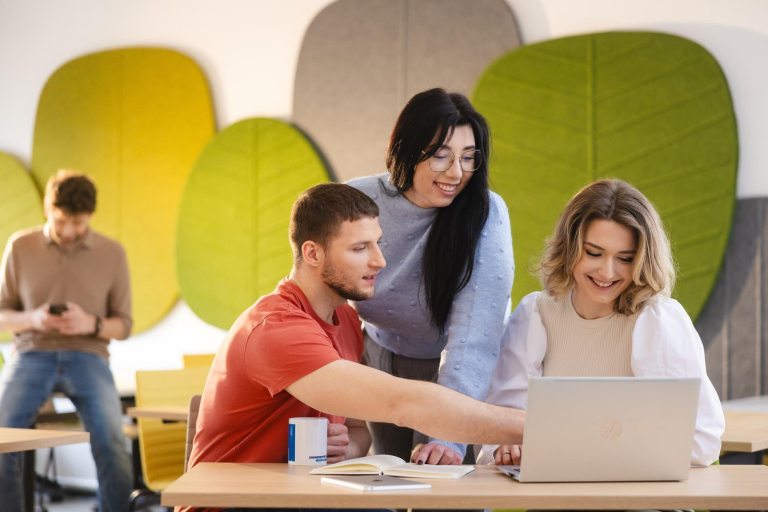 Digital university | Uniwersytet WSB Merito Szczecin: Grupa studentów przy komputerze, jeden z nich wskazuje na ekran