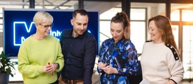 Academic promotions | Uniwersytet WSB Merito Szczecin: Studenci realizujący projekt przy stole na uzczelni WSB Merito