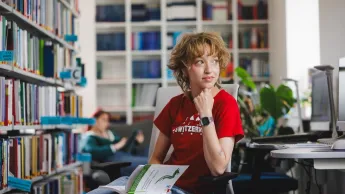Rachunkowość i sprawozdawczość finansowa z elementami ESG | Uniwersytet WSB Merito w Gdańsku: Studentka czyta książkę w bibliotece