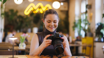 Studentka ogląda aparat typu lustrzanka