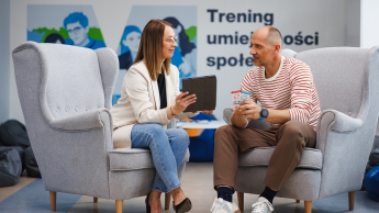 Pedagogika senioralna z animacją społeczno-kulturalną | Studia I stopnia w Gdańsku | Uniwersytet WSB Merito w Gdańsku: Rozmowa na fotelach pomiędzy kobietą a mężczyzną w tle napis - trening umiejętności społecznych