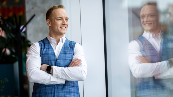 Zarządzanie przedsiębiorstwem | Studia II stopnia ze studiami podyplomowymi  | Uniwersytet WSB Merito w Gdańsku: Zdjęcie biznesowe studenta z odbiciem w oknie