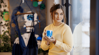 Studentka w strefie studenta z kubkiem w dłoni