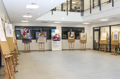 Nowoczesne pracownie i laboratoria | Uniwersytet WSB Merito w Gdańsku: Atrium ze sztalugami i rull upuem MIG