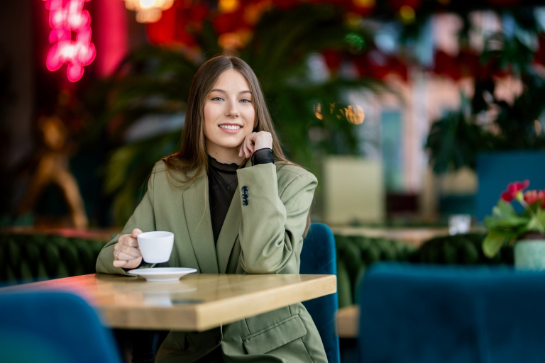 Zarządzanie | Studia II stopnia ze studiami podyplomowymi w Gdańsku | Uniwersytet WSB Merito w Gdańsku: Studentka w marynarce z kawą w kawiarni 