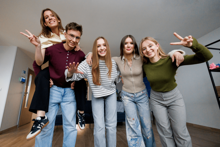 Poznaj nas | Uniwersytet WSB Merito w Gdańsku: Studenci na korytarzu pozują do zdjęcia grupowego