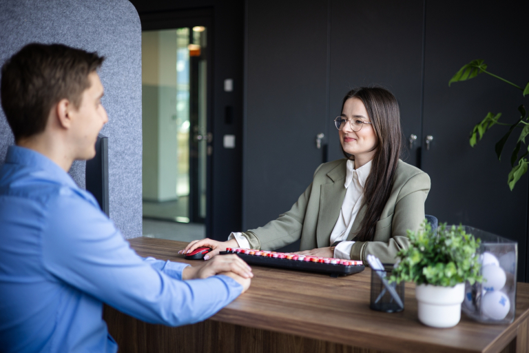 Automatyzacja procesów biznesowych | Studia podyplomowe w Gdyni | Uniwersytet WSB Merito Gdynia: Zdjęcie kobiety rozmawiającej z mężczyzną w sprawach służbowych