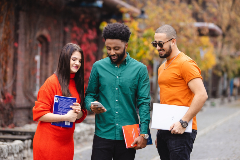 Studia i praktyki za granicą | Uniwersytet WSB Merito Gdynia: Studenci jesienią na dworze podczas rozmowy