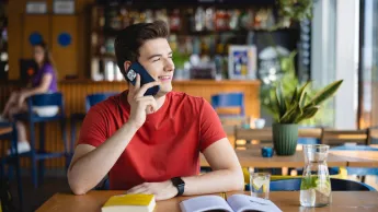 Zamówienia publiczne | Studia podyplomowe w Łodzi | Uniwersytet WSB Merito Łódź: Student Uniwersytetu WSB Merito w Łodzi rozmawia przez telefon.