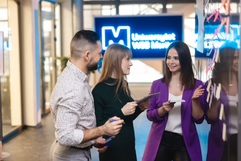 Logistyka 5.0 | Studia II stopnia ze studiami podyplomowymi  | Uniwersytet WSB Merito Łódź: Studenci Uniwersytetu WSB Merito w Łodzi rozmawiają ze sobą.