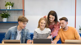 Praca z osobami niedostosowanymi społecznie z profilaktyką uzależnień | Studia I stopnia w Opolu | Uniwersytet WSB Merito Opole: Główna grafika: Opole - specjalnośc Praca z osobami niedostosowanymi społecznie z profilaktyką uzależnień - grupa studentów pracująca przed komputerem, który ustawiony jest na blacie stołu