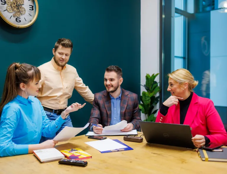 Prawo w finansach | Studia I stopnia w Opolu | Uniwersytet WSB Merito Opole: Główna grafika: Opole - specjalność Prawo e-biznesu i sztucznej inteligencji - grupa studentów siedząca za stołem, przed komputerem 