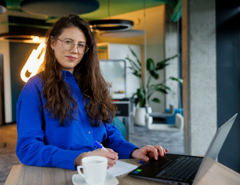 Zarządzanie jakością | Studia podyplomowe w Opolu | Uniwersytet WSB Merito Opole: Uczestniczka studiów podyplomowych pracuje na laptopie