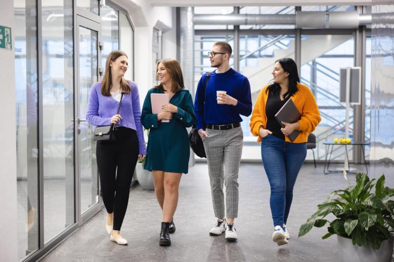 Neurologopedia | Studia podyplomowe w Szczecinie | Uniwersytet WSB Merito Szczecin: Studenci Uniwersytetu WSB Merito rozmawiający na korytarzu uczelni.