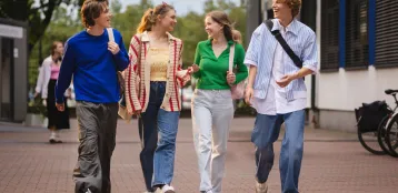 Strona główna | Uniwersytet WSB Merito w Toruniu: Studenci idą i rozmawiają przed uczelnią