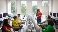 Projektowanie gier komputerowych | Studia podyplomowe we Wrocławiu | Uniwersytet WSB Merito we Wrocławiu: studenci podczas zajęć w pracowni komputerowej apple imac