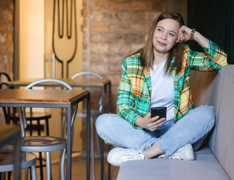 Social media w biznesie | Studia I stopnia we Wrocławiu | Uniwersytet WSB Merito we Wrocławiu: studentka używająca telefonu