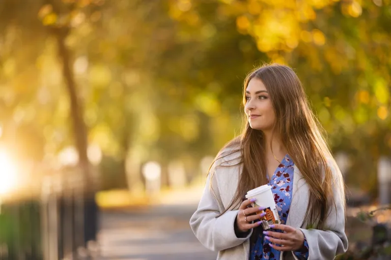 Prawo w zarządzaniu | Studia I stopnia we Wrocławiu | Uniwersytet WSB Merito we Wrocławiu: studentka pozująca do zdjęcia trzymająca kubek kawy
