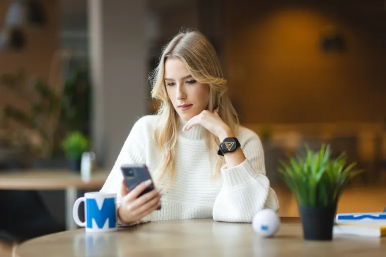 Język norweski w środowisku biznesowym | Uniwersytet WSB Merito we Wrocławiu: studentka patrząca w telefon